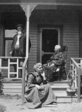 A man and two women on their front porch
